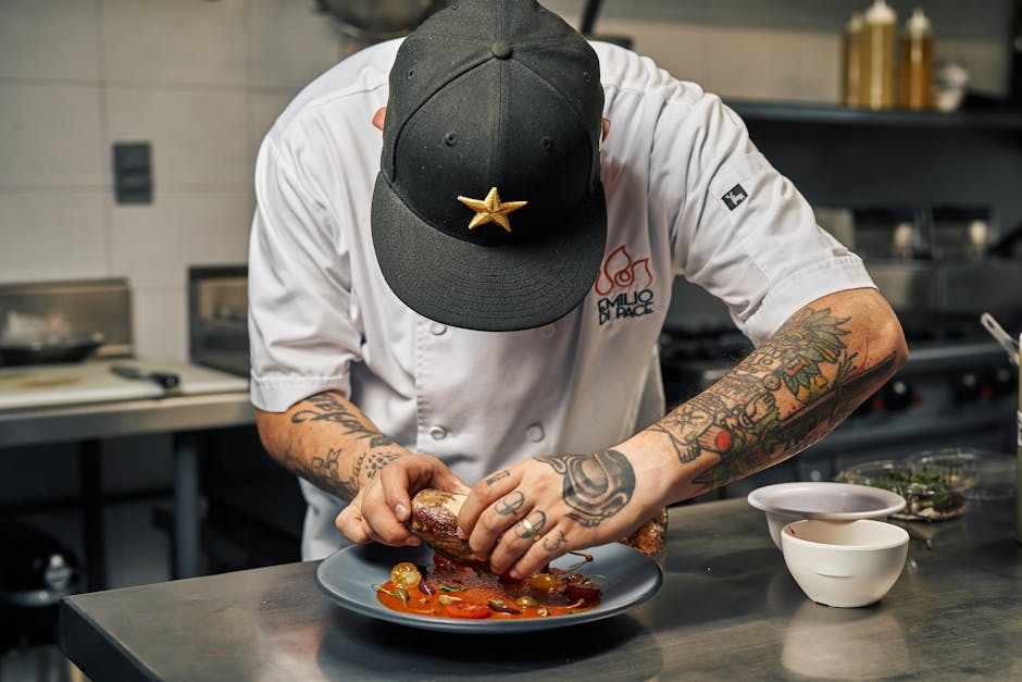 Chef meticulously plating gourmet food in a professional kitchen
